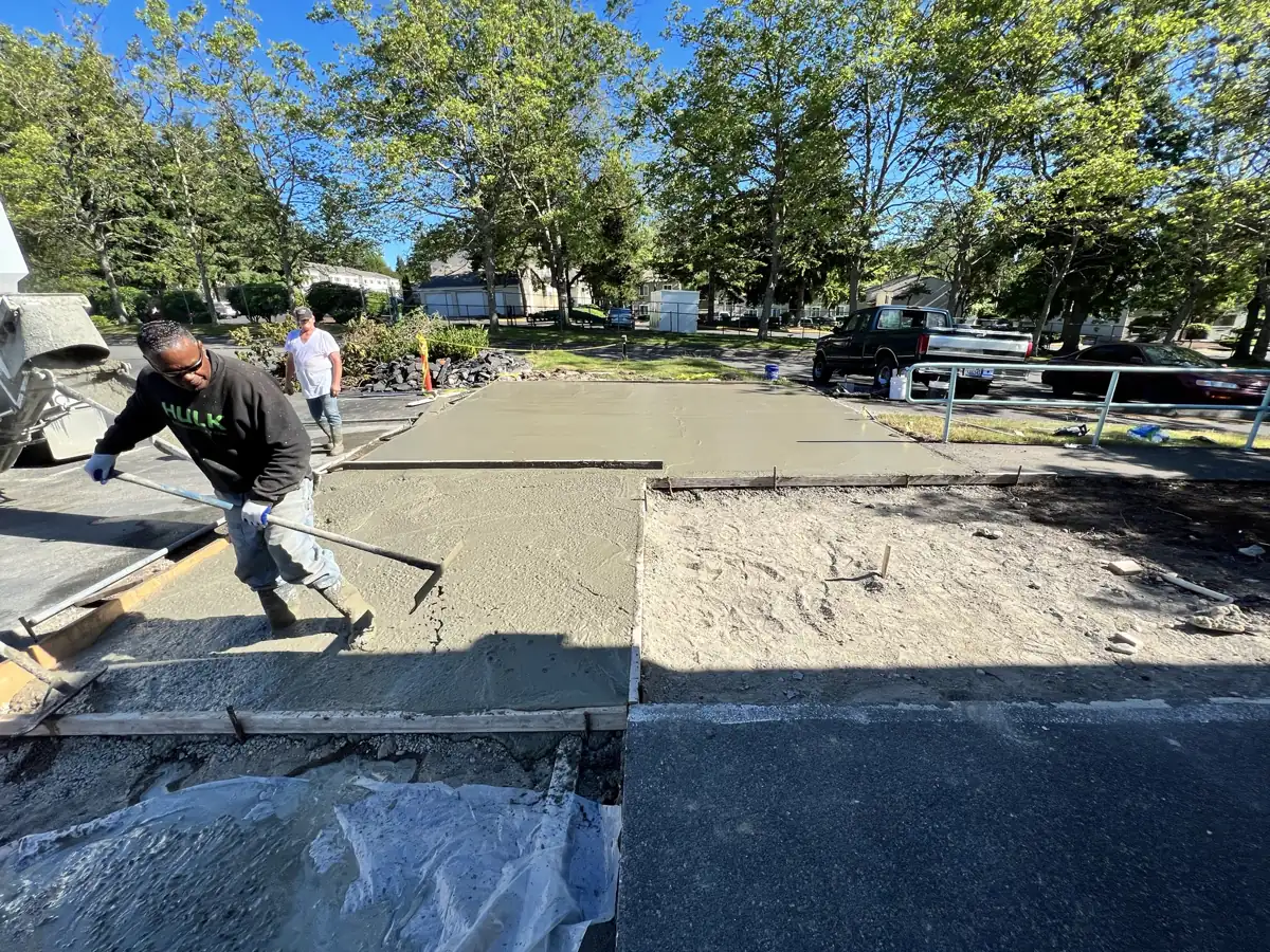 Finishing a new concrete sidewalk