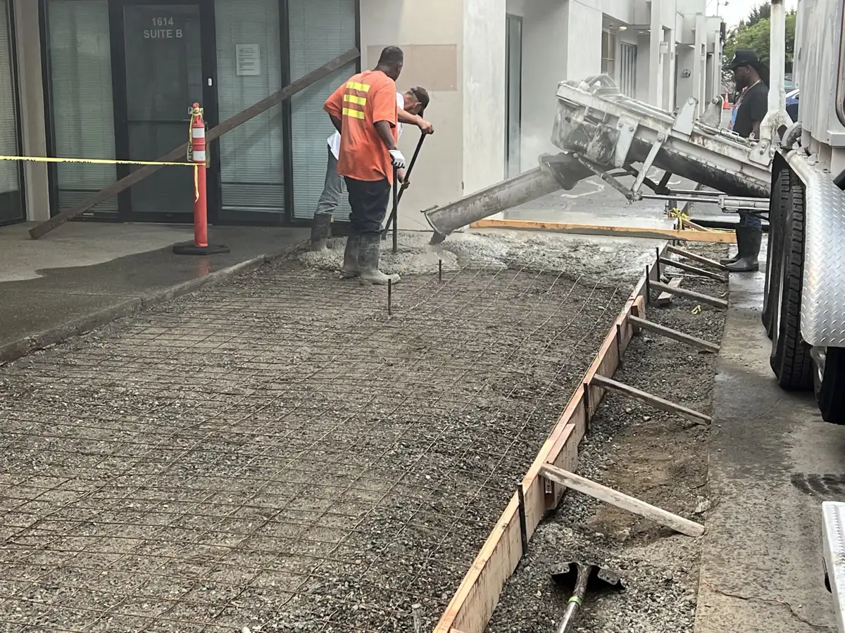 Screeding and finishing a curb-to-building sidewalk pour