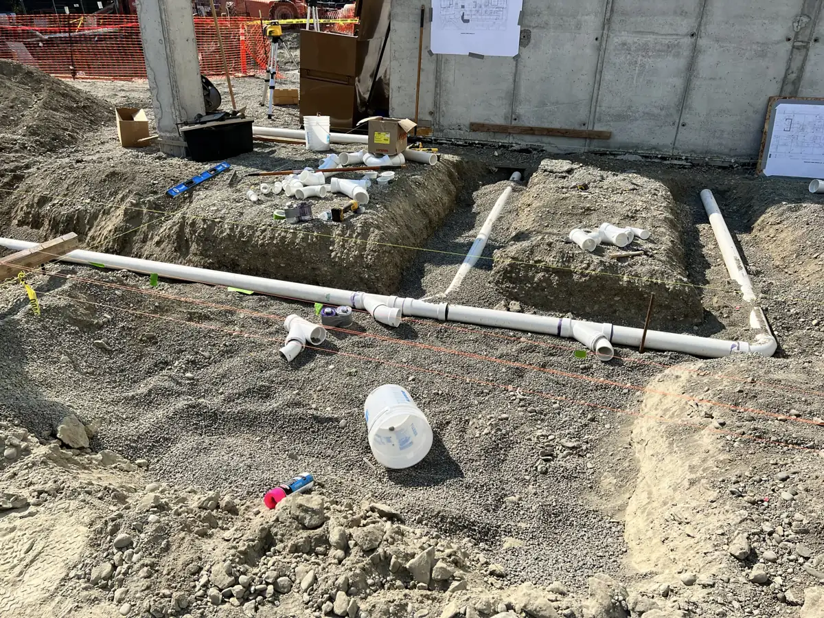 Under-slab plumbing and utility trenching