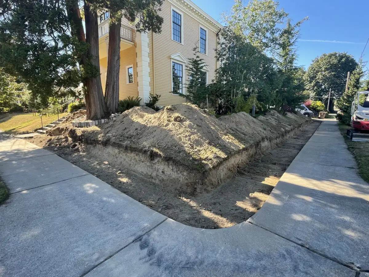Retaining wall: excavated and cut back along the sidewalk