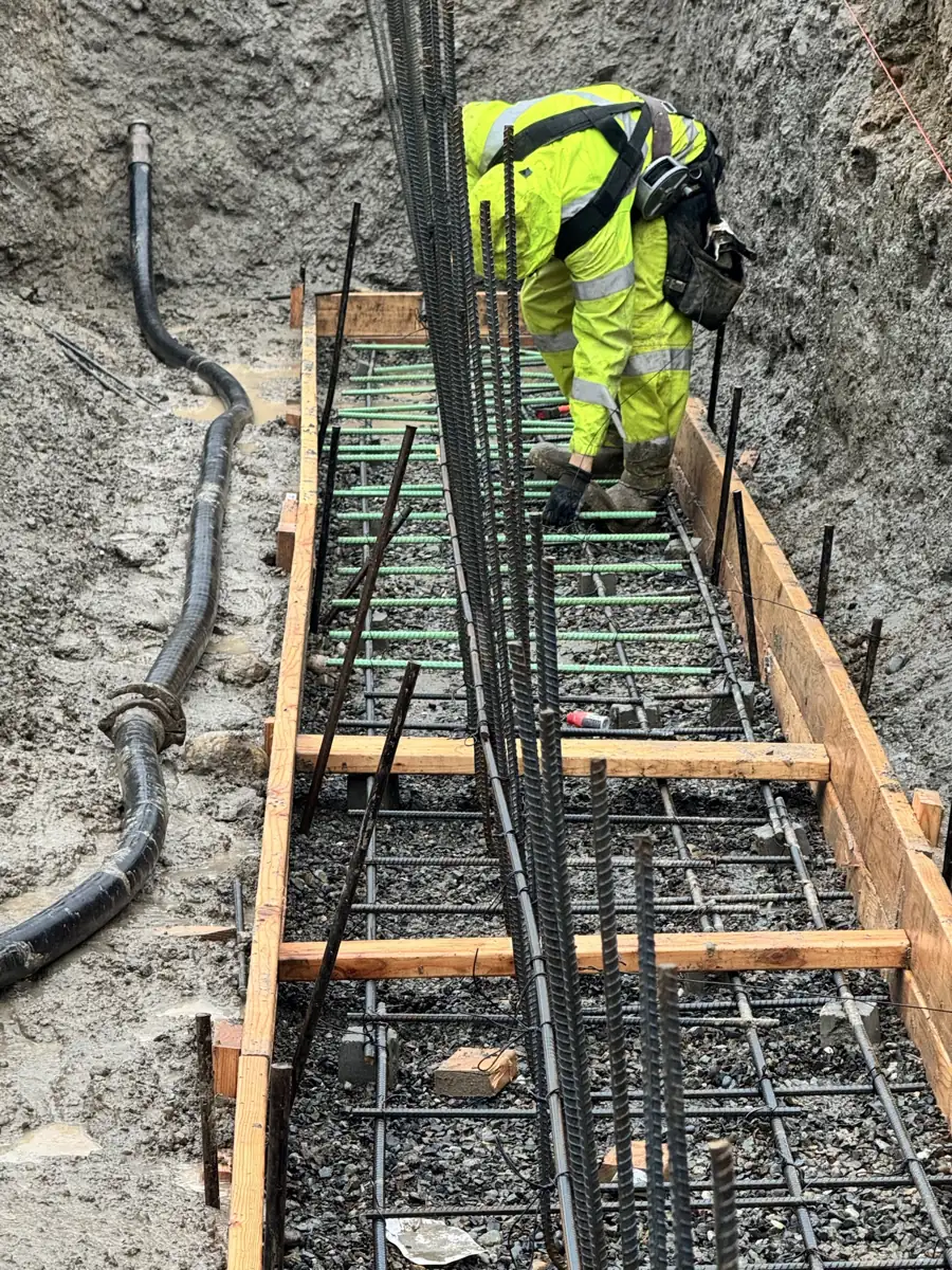 Tying rebar and setting conduit in a footing