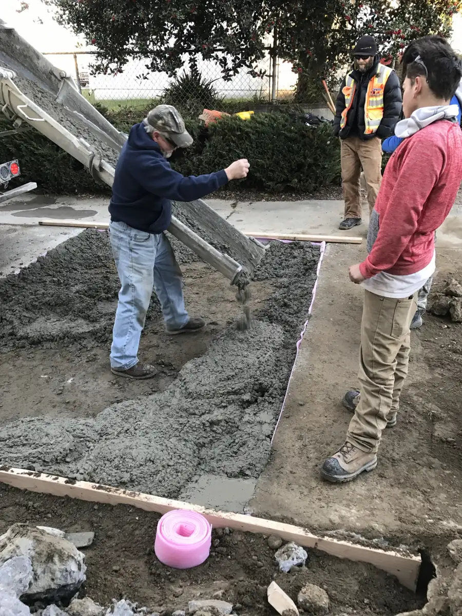 Chuting and screeding a concrete walkway