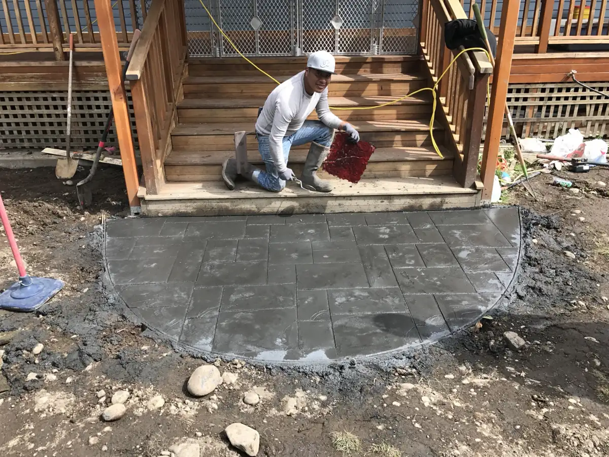Stamped concrete landing at a rear deck stair