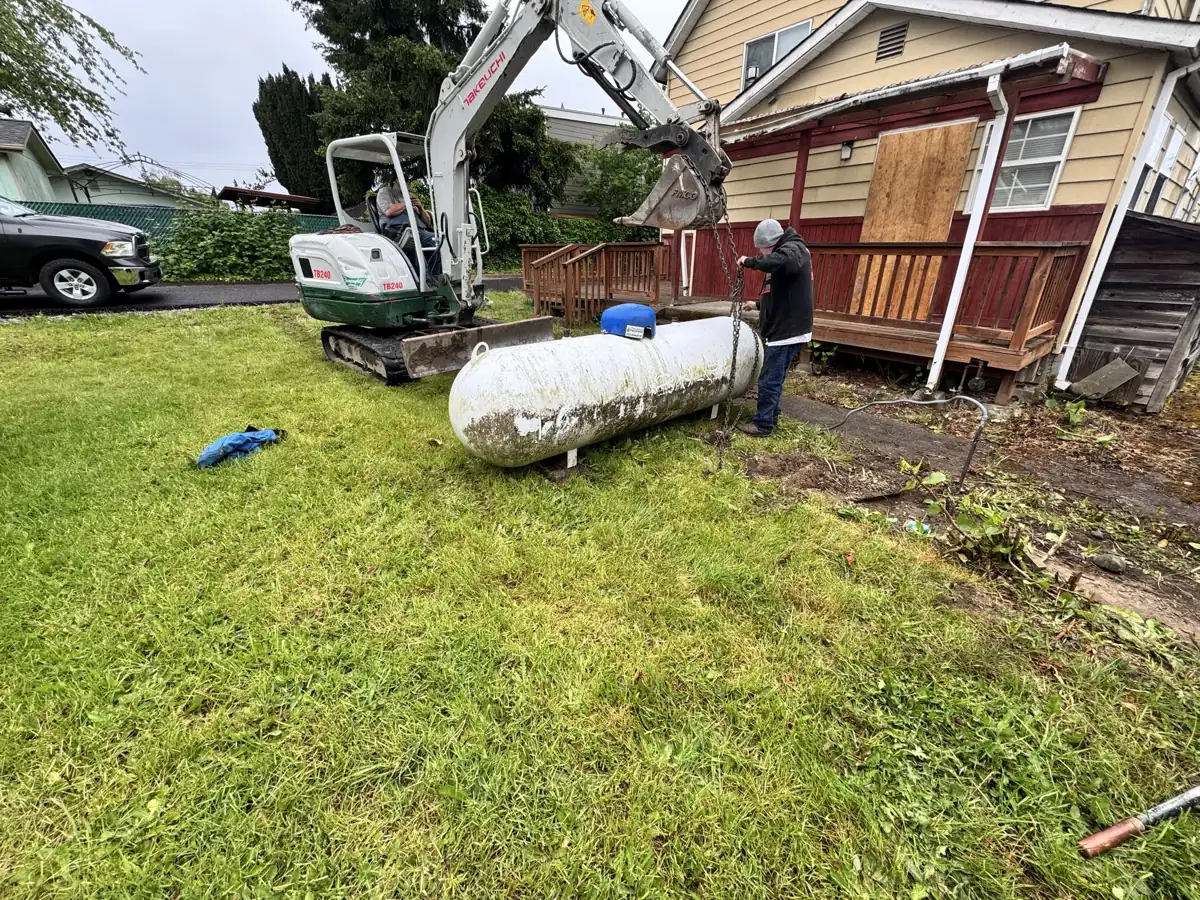 Removing an old propane tank with a mini excavator