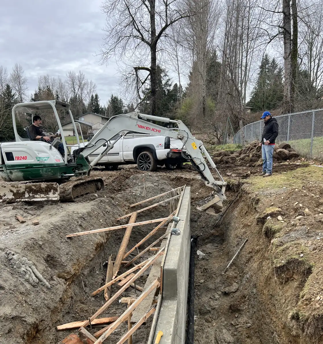 Excavating and backfilling behind a new retaining wall